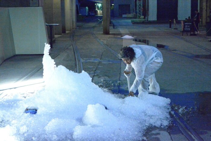 Latai Taumoepeau shoveling ice on the sidewalk.